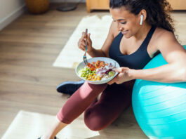 Frau mit Gymnastikball und Bowl pflegt einen gesunden Lebensstil
