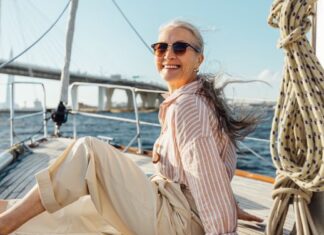 Frau entspannt auf einem Segelboot - Wie viel Geld brauchst du im Alter wirklich?